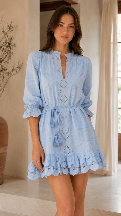 Front view of sky blue eyelet embroidered mini dress with tie waist and ruffle hem